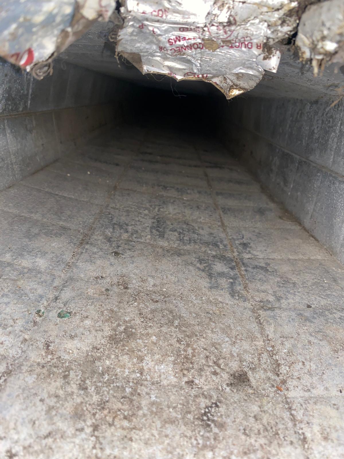 Damaged rectangular duct requiring repair